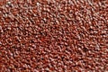 coarse-grained red-colored sandpaper close-up