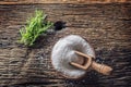 Coarse-grained salt with rosemary herbs in a wooden bowl with a ladle on an old oak table Royalty Free Stock Photo