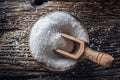 Coarse-grained salt in a wooden bowl with a ladle on an old oak table Royalty Free Stock Photo