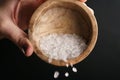 Coarse sea salt crystal falling from bowl