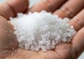 Coarse white salt crystals are held in an open hand. The salt Royalty Free Stock Photo
