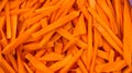 Coarsely chopped orange carrot. The process of cooking pilaf. Fresh natural vegetables background