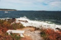 Coast of the Atlantic Ocean. Bench on the cliff near the ocean, raging waves.Maine. Portland.