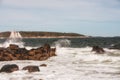 Coast of the Atlantic Ocean. A sailboat floating among the waves.