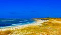 Coast atlantic ocean, waves, blue sky and lighthouse