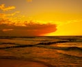 Coast of baltic sea with wooden breakwaters at sunset Royalty Free Stock Photo