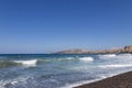 Coast and beach of Vlychada on Santorini island in Greece. In the background blue sky and waves at sea Royalty Free Stock Photo