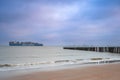 Coast of Breskens during sunrise, With a Cargoship in the background Royalty Free Stock Photo