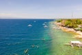 Coast of Cebu island, Moalboal, Philippines, top view. Boats near the shore in sunny weather