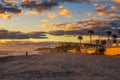 Coast of Daytona Beach in Florida at sunrise with people and palm trees Royalty Free Stock Photo