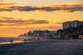 Coast of Daytona Beach in Florida at sunrise with people and palm trees Royalty Free Stock Photo