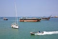 Coast Guard boat goes by luxury sailing boat, fishing and cargo ships