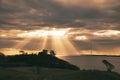 On the coast of Hundested. Sun rays break through the dramatic sky through the clouds Royalty Free Stock Photo