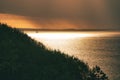 On the coast of Hundested. Sun rays breaking through the dramatic sky through the clouds Royalty Free Stock Photo