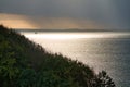 On the coast of Hundested. Sun rays breaking through the dramatic sky Royalty Free Stock Photo