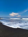 the coast of the Indian Ocean of black volcanic sand. Amed beach, Bali island, Indonesia. Royalty Free Stock Photo