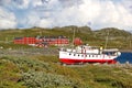 Coast of lake Bygdin with boat and traditional norwegian buildings