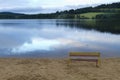 Lonesome bench at the coast of a lake Royalty Free Stock Photo