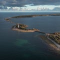 Coast and lighthouse Lange Erik in the north of the island of Ãland in the east of Sweden from above in the sun