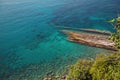 Aerial view of an amazing rocky and green coast bathed by a transparent and turquoise sea. Liguria, Italy. Royalty Free Stock Photo