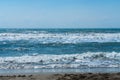 Coast of Mediterranean Sea in Fethiye, Turkey. Turquoise foamy waves run to the sand beach
