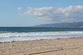 Coast of the Pacific Ocean in Los Angeles with mountains on the horizon and clouds Royalty Free Stock Photo