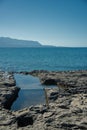 Remains of a sunken ancient settlement at the coast of Pounta beach Royalty Free Stock Photo