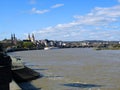 Coast of the Rheine, Germany, wide fast river, many beautiful houses, mountain slopes, blue sky, spring greenery Royalty Free Stock Photo