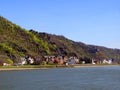 Coast of the Rhine, Germany, wide fast river, many beautiful houses, mountain slopes, blue sky, spring greenery Royalty Free Stock Photo