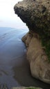 Two smiling human faces, Indonesia beach rock formation by erosion Royalty Free Stock Photo