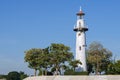 Coast white lighthouse blue sky background Royalty Free Stock Photo