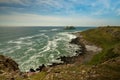 Coastal bay with waves flowing in on pebble beach Royalty Free Stock Photo