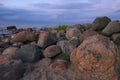 Coastal Boulder Pile on Baltic Shore Under Soft Summer Twilight with Dramatic Cloudscape and Natural Rugged Beach Texture Royalty Free Stock Photo