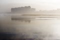 Coastal city reflected in the beach