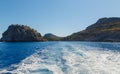 Coastal cliffs. Deep blue sea water. Sea waves with white foam and spray. Coast of the Mediterranean Sea. Rhodes, Greece Royalty Free Stock Photo