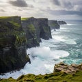 Coastal cliffs rise steeply from the Atlantic Ocean, with waves Royalty Free Stock Photo