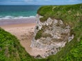 Coastal cliffs showing exposed strata near Portrush on the Antrim Causeway Coast Path - these rocks are of the Hibernian Royalty Free Stock Photo