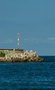 Coastal defense with graffiti and a beacon in the sunset