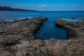 Coastal erosion ,hole in rocky beach in the shape of a heart ,saint florent ,corsica concept of romatic holidays