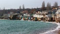 Coastal erosion - houses built on weak clay soil slide down to t Royalty Free Stock Photo