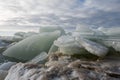 Coastal ice hummocks against the background of a cloudy sky Royalty Free Stock Photo