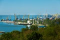 Coastal industrial port, cargo cranes dominate skyline. Ships docked at harbor, blue sea background. Trade hub, maritime Royalty Free Stock Photo