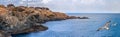 Coastal landscape banner, panorama - the rocky seashore with seagulls and the village of Sozopolis Royalty Free Stock Photo