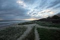 Coastal landscape. Bleak weather cloudscape with sun on the horizon Royalty Free Stock Photo