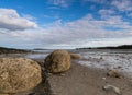 Coastal landscape at low tide with large rocks under a blue sky in Fundy Bay