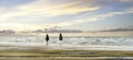 two young women riding horses on the beach at sunset Royalty Free Stock Photo