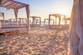 Coastal landscape - view of the sandy seashore with beach gazebos Royalty Free Stock Photo