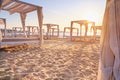 Coastal landscape - view of the sandy seashore with beach gazebos Royalty Free Stock Photo