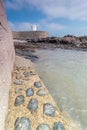 Coastal location around st michaels mount in cornwall england uk. Lookout post in Marizion harbour. White castlated building next Royalty Free Stock Photo