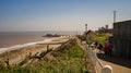 Coastal path towards the seaside town of Cromer, which the famous Victorian pier in the distance. UK weather: A bright and sunny, Royalty Free Stock Photo